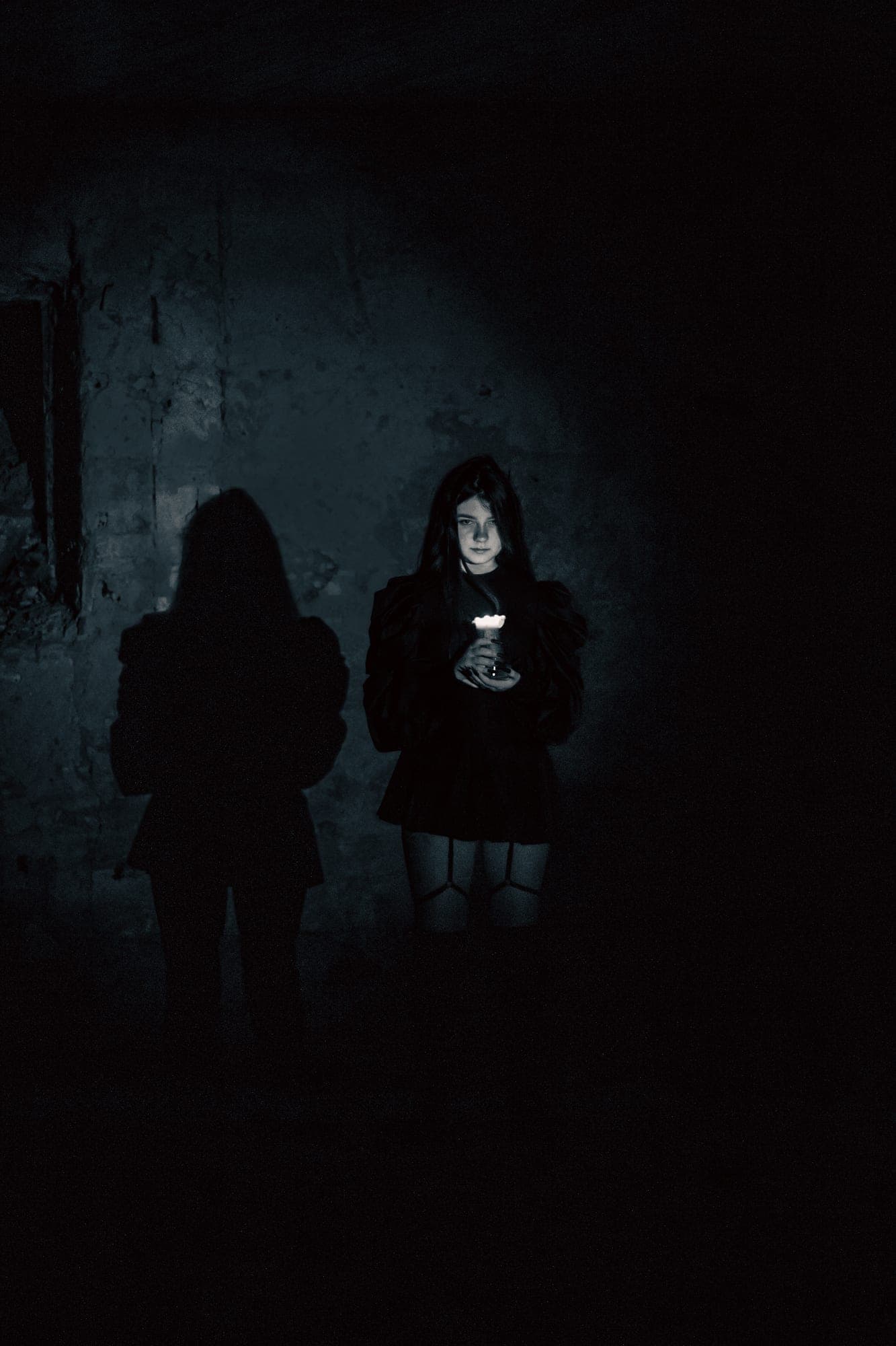 Ghost — figure holding light in darkness